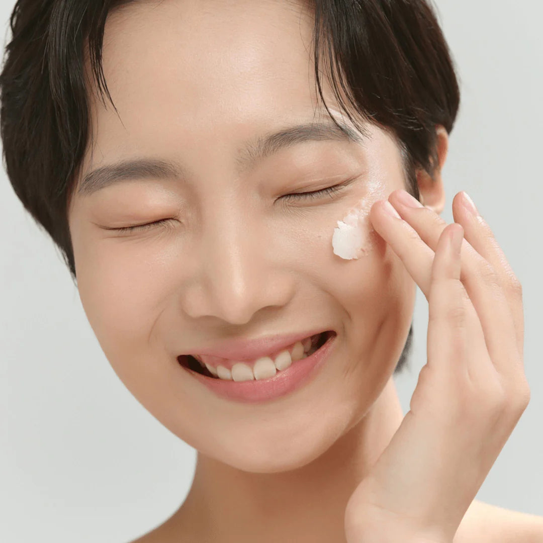 Model applying Beauty of Joseon Radiance Cleansing Balm – Korean cleansing balm for removing makeup and impurities.