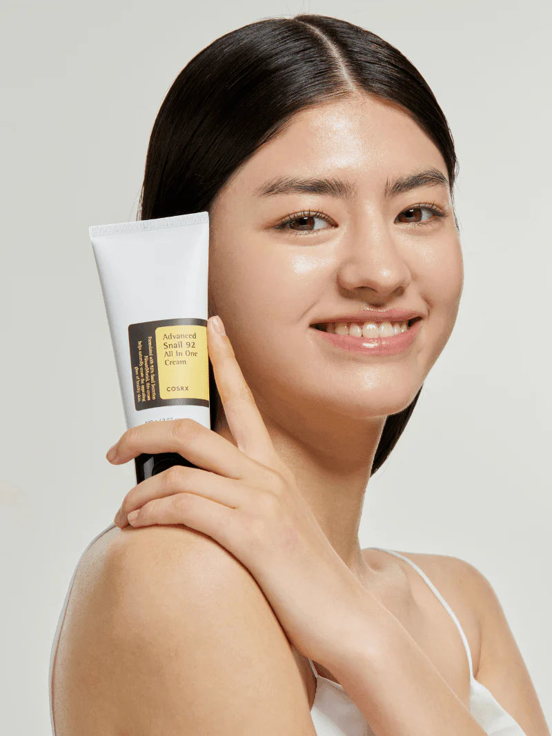 Applying COSRX Advanced Snail 92 Cream – nourishing moisturizer for plump and radiant skin